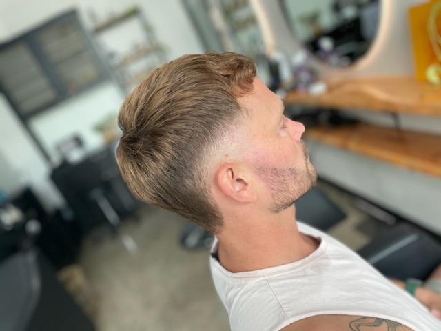 High skin fade and a clean beard line-up